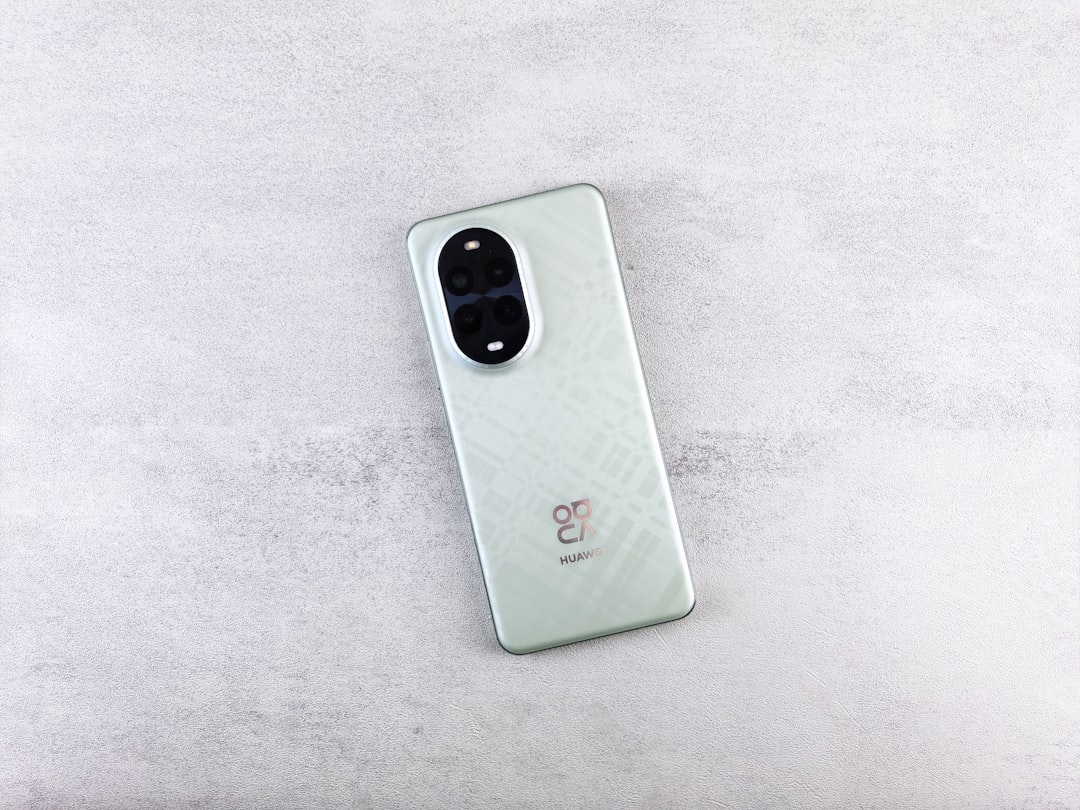 A mint green smartphone is lying on a table.