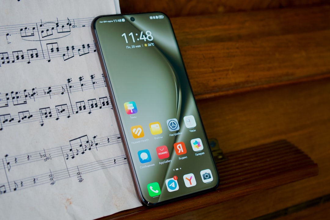 A cell phone sitting on top of a sheet of music