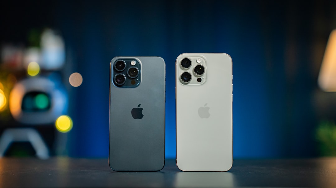 Two iphones sitting side by side on a table